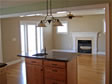 Proper placement of this elegant fireplace enabled views from both the kitchen and the family room